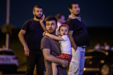 Turkey Airport Blasts A man carries his daughter