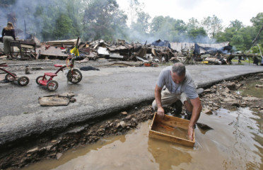 West Virginia floods Mark Lester cleans out a box with creek water