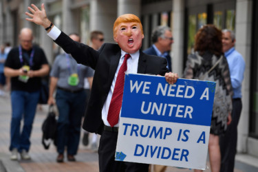 Demonstrations in Cleveland A man wearing a mask of Donald Trump