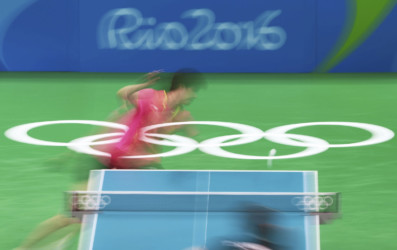 Olympians in motion: Table Tennis table tennis player swings paddle