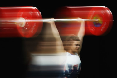 Olympians in motion: Weightlifting woman lifts weights