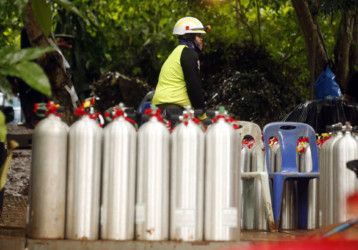 Thailand Cave Search Thai rescuer prepares oxygen tank for diving