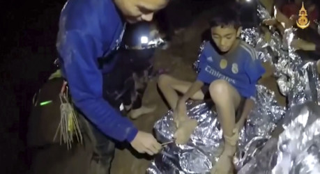 Thailand Cave Search Thai Navy SEAL medic helps an injured child