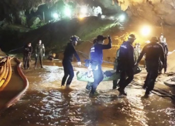 The Week That Was In Asia Photo Gallery Rescuers hold an evacuated boy inside the Tham Luang Nang Non cave