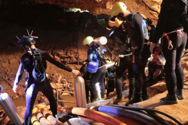 Thailand Cave Search Thai rescue team members walk inside a cave