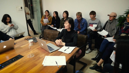 Road to Riches Catherine leading business meeting.
