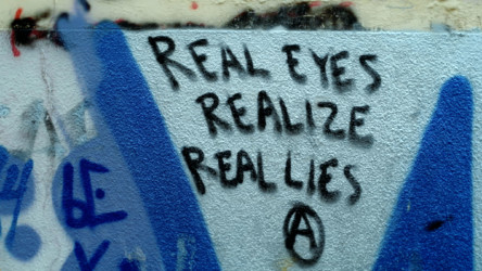 Another news story messages of support and contempt on wall near port