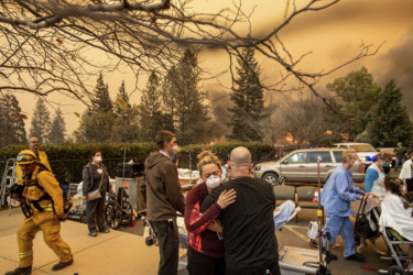 California Wildfires Nurse Cassie Lerossignol hugs a coworker as the Feather River Hospital burns