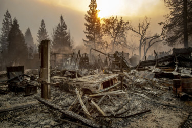 California Wildfires A vintage car rests among debris