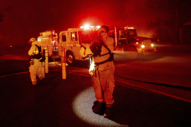 APTOPIX California Wildfires Firefighter Adrien Mahnke pauses while battling the Camp Fire