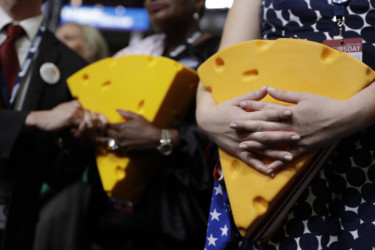 Wisconsin cheese delegates holding hats that look like cheese