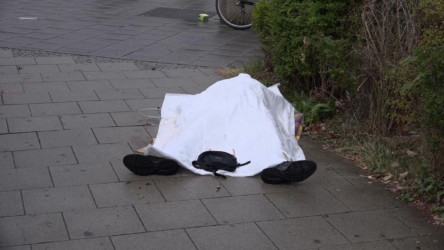 Dead body covered in sheet outside of Munich mall Body covered with a sheet outside a mall, in Munich, Germany,