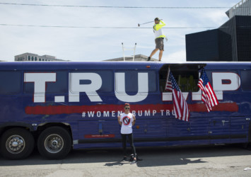 The Trump bus revisited artist on top of Trump bus