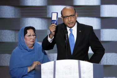 Parents of fallen Muslim soldier Khan holds up a copy of the Constitution