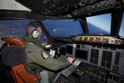 Captain Flt. Lt. Tim McAlevey of the Royal New Zealand Air Force flies a P-3 Orion in search for the missing Malaysia Airlines Flight 370 over the Indian Ocean, Friday, April 11, 2014. Authorities are confident that signals detected deep in the Indian Ocean are from the missing Malaysian jet's black boxes, Australian Prime Minister Tony Abbott said Friday, raising hopes they are close to solving one of aviation's most perplexing mysteries. Abbott told reporters in Shanghai that crews hunting for Flight 370 have zeroed in on a more targeted area in their search for the source of the sounds, first heard on Saturday. (AP Photo/Richard Wainwright, Pool)
