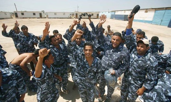 Iraqi volunteers wearing their new uniforms cheer as they gather at a center following a speech by #Iraqi Prime Minister Nuri al-Maliki who announced that the Iraqi government would arm and equip civilians who volunteer to fight against jihadists militants, on June 16, 2014, in the central Shiite Muslim Shrine city of Karbala. Since June 10, militants led by the Islamic State of Iraq and the Levant (ISIL) jihadist group have taken control of vast swathes of territory of north and north-central Iraq.