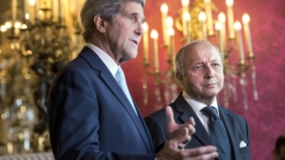 rench Foreign Affairs Minister Laurent Fabius (R) listens as US Secretary of State John Kerry makes statements to the press
