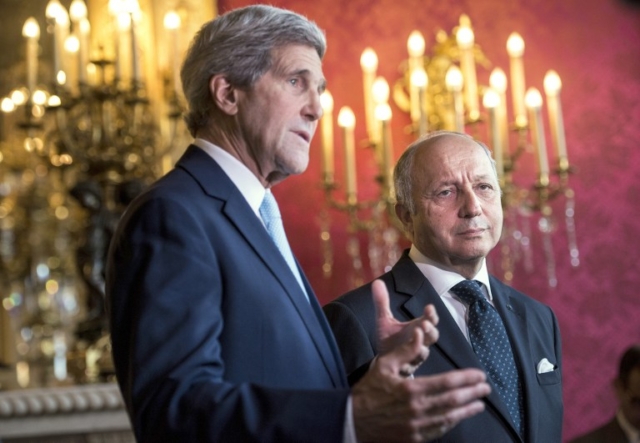 rench Foreign Affairs Minister Laurent Fabius (R) listens as US Secretary of State John Kerry makes statements to the press