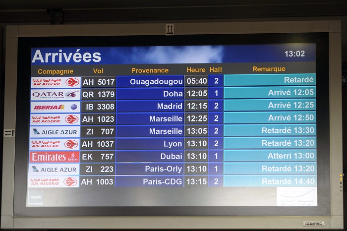 An arrival information screen shows the delayed Air Algerie flight 5017 (top) at the Houari Boumediene airport near Algiers, Algeria on Thursday, July 24, 2014. (AP Photo/Sidali Djarboub)