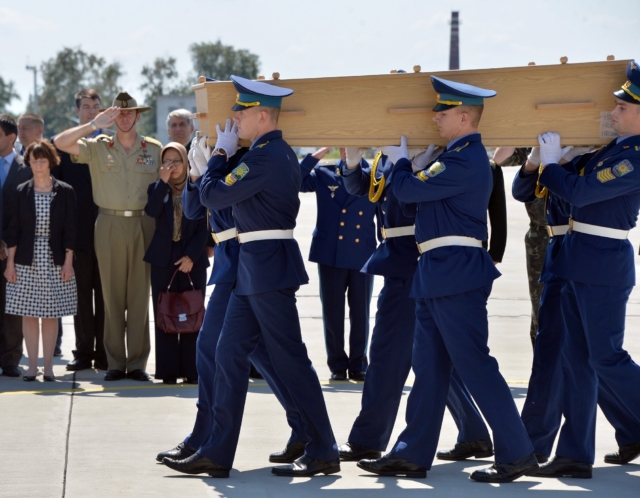 Ukrainian soldiers carry a coffin with the remains of a victim of the Malaysia Airlines flight MH17 crash