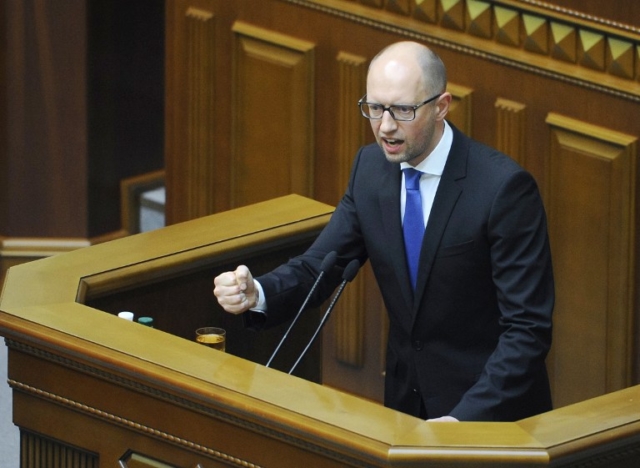 Ukrainian Prime Minister Arseniy Yatsenyuk gesturing as he addresses members of parliament