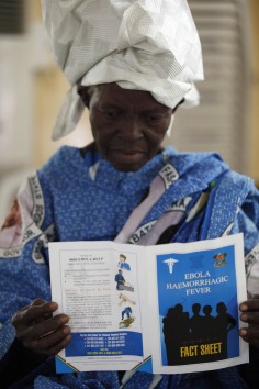 A woman reads a fact sheet for the Ebola virus during an awareness campaign in Lagos, Nigeria,  Friday, Aug. 15, 2014. Photo: AP/Sunday Alamba