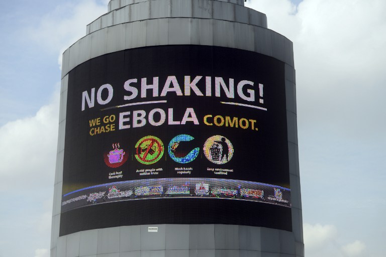 A picture taken in Oshodi Heritage park in Lagos on October 20, 2014 shows an electronic information board on Ebola reading in pidgin English "No Shaking ! We go Chase Ebola Comot" which means "No cause for worry, we will chase Ebola away". (Photo: AFP)
