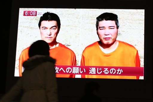  Japanese hostages Kenji Goto, left, and Haruna Yukawa (AP Photo/Eugene Hoshiko)