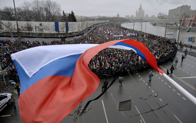 Russia's opposition supporters march in memory of murdered Kremlin critic Boris Nemtsov in central Moscow on March 1, 2015. The 55 year old former first deputy prime minister under Boris Yeltsin was shot in the back several times just before midnight on February 27 as he walked across a bridge near the Kremlin walls.  AFP/ Yuri Kadobnov