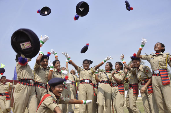 Indian policewomen throw their berets into the air as they celebrate becoming female constables at a police training ground on the outskirts of Agartala on March 2, 2015.  AFP/ Arindam Dey