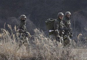 South Korean army soldiers move during their military exercise near the demilitarized zone between the two Koreas in Paju, South Korea, Monday, March 2, 2015. North Korea on Monday fired two short-range ballistic missiles into the sea and warned of "merciless strikes" against its enemies as allies Seoul and Washington launched annual military drills Pyongyang claims are preparation for a northward invasion.(AP Photo/Ahn Young-joon)