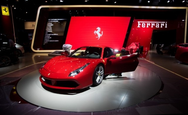 A worker cleans a Ferrari ahead of the 16th Shanghai International Automobile Industry Exhibition in Shanghai on April 19, 2015. China is crucial to foreign carmakers as the world's biggest auto market, but slowing economic growth and a corruption crackdown are denting its appeal as they gather for the country's premier industry show. AFP PHOTO / JOHANNES EISELE