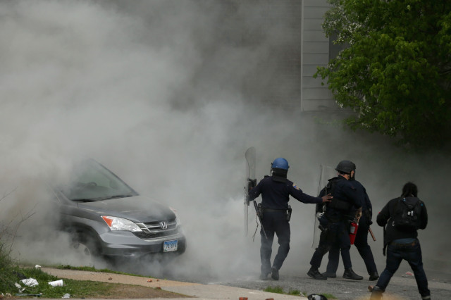 BALTIMORE, MD - APRIL 27: Baltimore Police officers use tear gas to disperse protesters outside the Mondawmin Mall following the funeral of Freddie Gray April 27, 2015 in Baltimore, Maryland. Gray, 25, who was arrested for possessing a switch blade knife April 12 outside the Gilmor Homes housing project on Baltimore's west side. According to his attorney, Gray died a week later in the hospital from a severe spinal cord injury he received while in police custody.   Chip Somodevilla/Getty Images/AFP