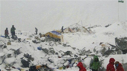 In this photo provided by Azim Afif people approach the scene after an avalanche triggered by a massive earthquake swept across Everest Base Camp, Nepal on Saturday, April 25, 2015. Afif and his team of four others from the Universiti Teknologi Malaysia (UTM) all survived the avalanche. (Azim Afif via AP)
