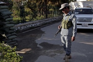 An Afghan policeman looks at a bloodstained pavement at the site of an attack by an Afghan national army soldier who opened fire on U.S. troops, at the compound of the provincial governor, in Jalalabad, Afghanistan, Wednesday, April 8, 2015. An American soldier was killed in the shooting Wednesday in which at least two other U.S. troops were wounded. The incident happened after a meeting between Afghan provincial leaders and a U.S. Embassy official. (AP Photo/Rahmat Gul)