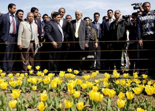 Jammu and Kashmir state Chief Minister Mufti Mohammad Sayeed (center wearing a yellow tie) admires the colorful tulips during the season's opening of the garden in the Siraj Bagh locality in India's Kashmir region.  (AP/ Mukhtar Khan)