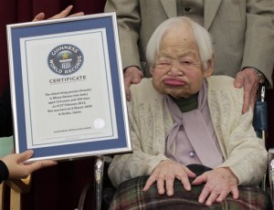 FILE - In this Feb. 27, 2013 file photo, Japan's Misao Okawa, then 114, poses with the certificate of the world's oldest woman, which was presented to her by Guinness World Records Japan Country Manager Erika Ogawa, unseen, at a nursing home in Osaka, western Japan. The world's oldest person has died nearly a month after celebrating her 117th birthday. (AP Photo/Itsuo Inouye, File)