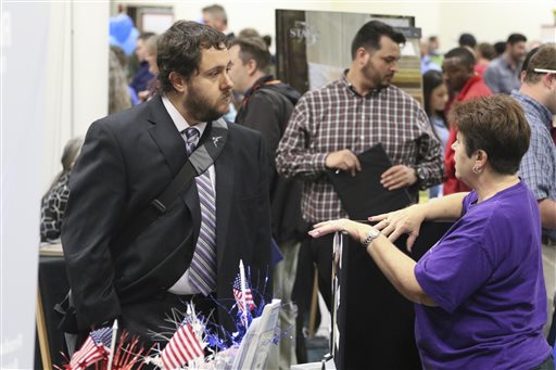 In this April 2, 2015 photo, Nathan Golder, left, speaks to Deborah Kelley, with the Georgia National Guard Family Assistance Center, about employment opportunities during a huge 15-county North Georgia job fair at The Colonnade in Ringgold, Ga. Labor Department releases job openings and labor turnover survey for February on Tuesday, April 7, 2015. (AP Photo/Chattanooga Times Free Press, Dan Henry) THE DAILY CITIZEN OUT; NOOGA.COM OUT; CLEVELAND DAILY BANNER OUT; LOCAL INTERNET OUT