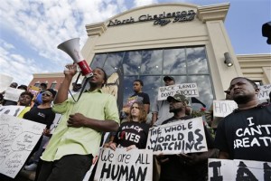 Muhiydin D'Baha leads a group protesting the shooting death of Walter Scott at city hall in North Charleston, S.C., Wednesday, April 8, 2015. Scott was killed by a North Charleston police office after a traffic stop on Saturday. The officer, Michael Thomas Slager, has been charged with murder. (AP Photo/Chuck Burton)