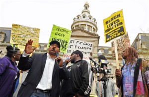 Edward Brown speaks at a protest outside City Hall about Freddie Gray in Baltimore, Monday, April 20, 2015. Baltimore's top police officials, mayor and prosecutor sought to calm a "community on edge" Monday while investigating how Gray suffered a fatal spine injury while under arrest. Six officers have been suspended, but investigators say they still don't know how it happened. (Amy Davis/The Baltimore Sun via AP)