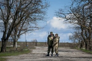 Russian General Alexander Lentsov speaks with Ukrainian General Alexander Rozmaznin in Shyrokyne village, eastern Ukraine, Thursday, April 9, 2015. The OSCE also reported intense mortar fire outside the village of Shyrokyne by the Azov Sea but said its representatives were repeatedly barred from accessing the village on Sunday, April 12, 2015. (AP Photo/Evgeniy Maloletka)