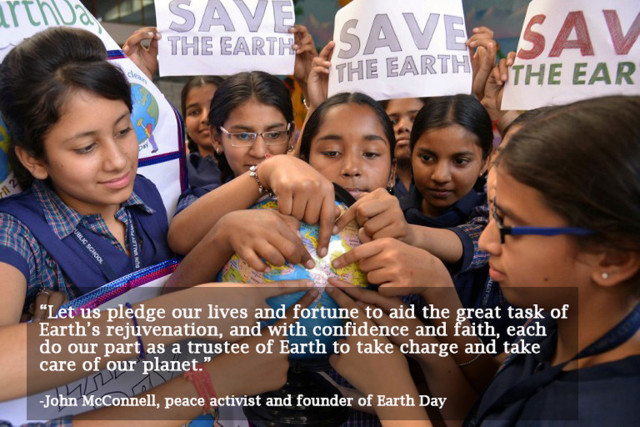 Indian school girls holds placards and a globe during an awareness campaign to mark Earth Day at a school in Amritsar on April 22, 2015. Earth Day is observed each April 22, during which events are held worldwide to demonstrate support for environmental protection. AFP PHOTO/NARINDER NANU