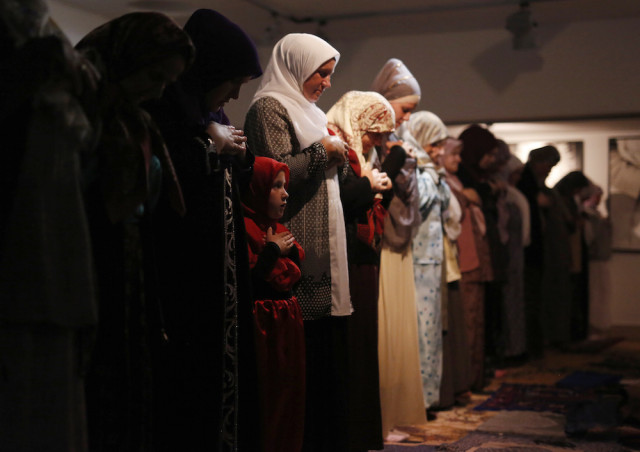 Bosnian Muslim during late night prayer for Ramadan, inside a memorial room for Srebrenica victims, at the memorial center Potocari,  150 kms north east of Sarajevo, on Wednesday, June, 17, 2015. (AP Photo/Amel Emric)