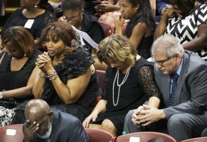 Mourners pray after President Barack Obama delivered the eulogy at the funeral service for Rev. Clementa Pinckney, Friday, June 26, 2015, in Charleston, S.C. (AP Photo/David Goldman)