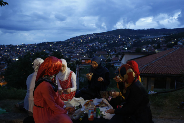 FILE - In this Tuesday, July 15, 2014 file photo, a group of young women break their fast during the holy Muslim month of Ramadan, on top of an old fortress overlooking the historic core of Sarajevo. Fasting is an exercise in self-restraint. It’s seen as a way to physically and spiritually detoxify by kicking impulses like morning coffee, smoking and midday snacking. (AP Photo/Amel Emric, File)