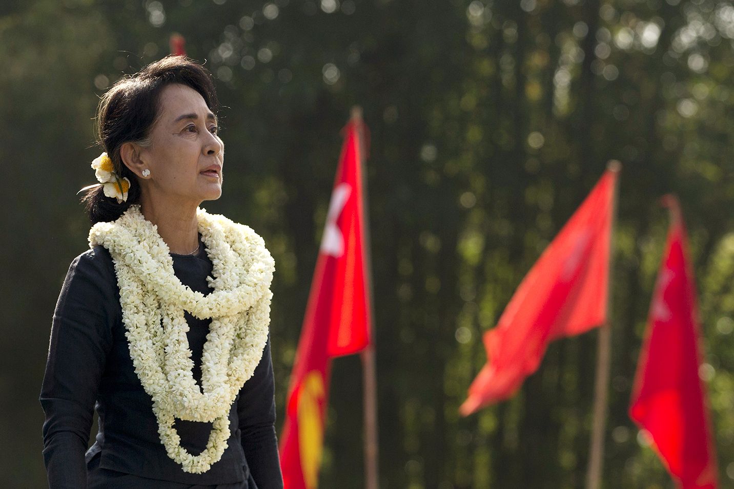 Who is Aung San Suu Kyi and why is she in China?