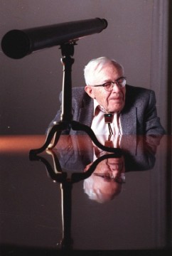 FILE- This 1990 file photo shows Clyde Tombaugh in New York. On Tuesday, July 14, 2015, NASA's New Horizons spacecraft, carrying a small canister with his ashes, is scheduled to pass within 7,800 miles of Pluto which he discovered 85 years ago. (AP Photo/Will Yurman, File)