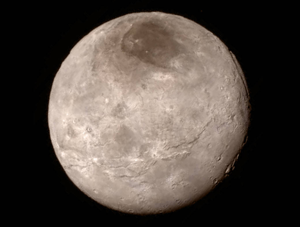 New details of Pluto’s largest moon Charon are revealed in this image from New Horizons’ Long Range Reconnaissance Imager (LORRI), taken late on July 13, 2015 from a distance of 289,000 miles  (466,000 kilometers). A swath of cliffs and troughs stretches about 600 miles (1,000 kilometers) from left to right, suggesting widespread fracturing of Charon’s crust, likely a result of internal processes. At upper right, along the moon’s curving edge, is a canyon estimated to be 4 to 6 miles (7 to 9 kilometers) deep. ( Credit: NASA-JHUAPL-SwRI)