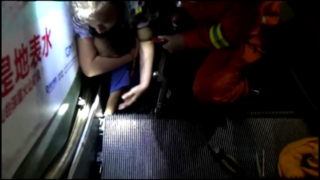 Child's hand caught in escalator