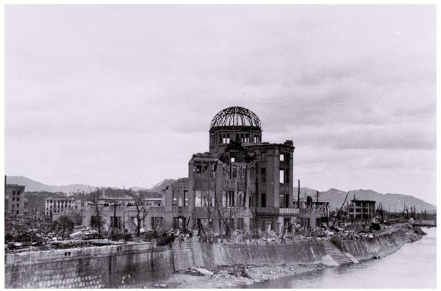 A combination picture shows the gutted Hiroshima Prefectural Industrial Promotion Hall, which is currently called the Atomic Bomb Dome or A-Bomb Dome, after the atomic bombing of Hiroshima on August 6, 1945. This undated handout photo (top) was taken by Toshio Kawahara and released by his grandchild Yoshio Kawamoto, with the picture below showing same location near Aioi Bridge in Hiroshima on July 28, 2015.